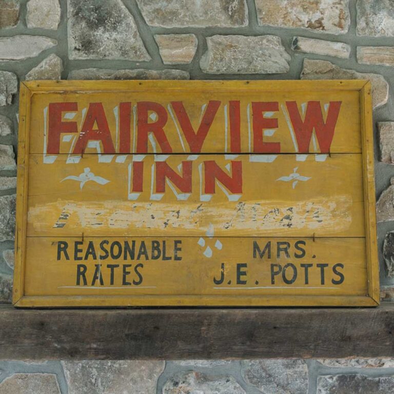 Original painted Fairview Inn sign reading Reasonable Rates, Mrs. J.E. Potts