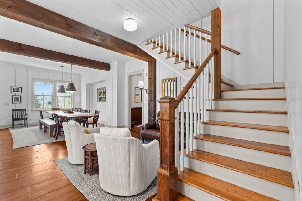Wooden staircase with white balusters in the great room