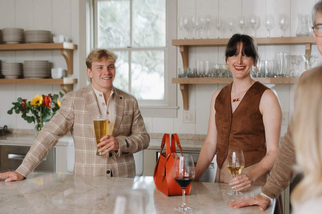 Two guests sharing a drink at the kitchen island