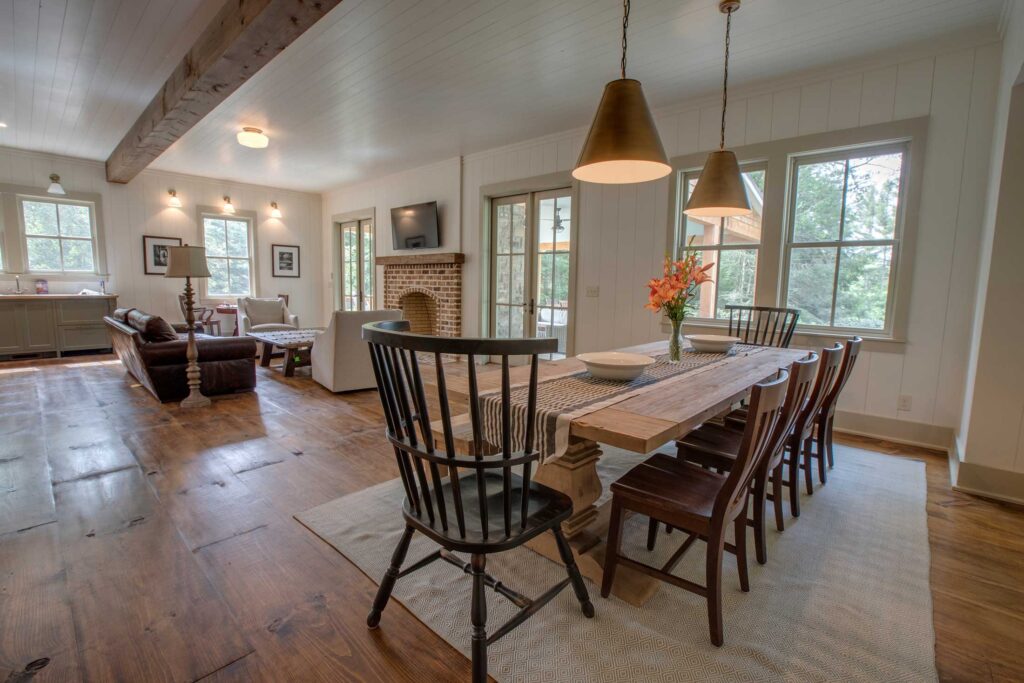 Long farmhouse dining table under pendant lights