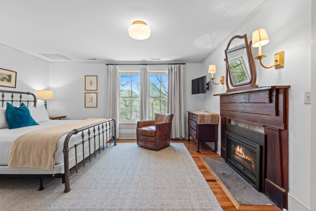 Bedroom with iron bed and a gas fireplace